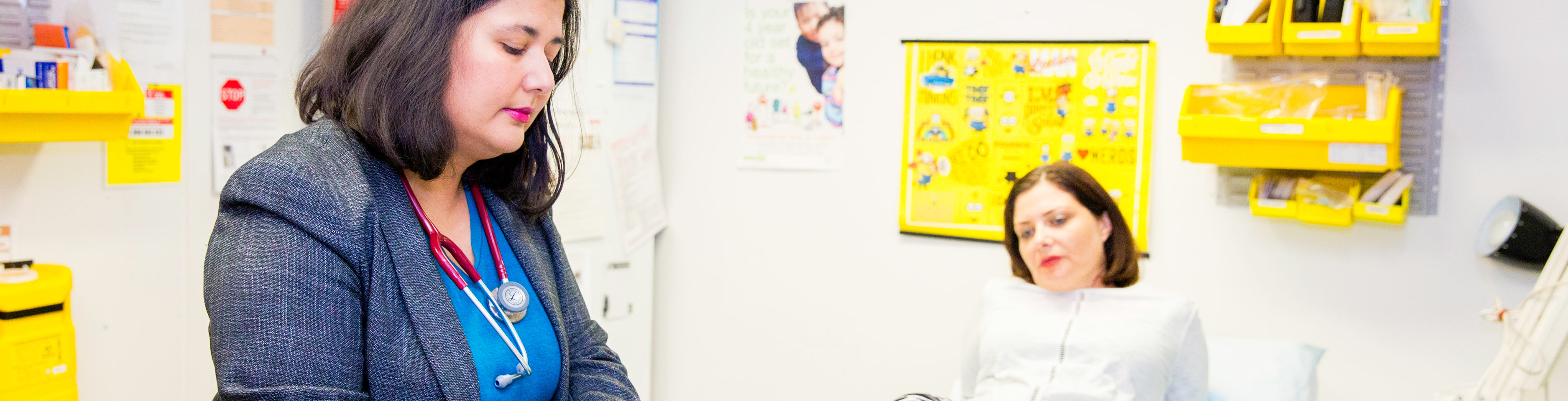 A female doctor treats a patient in her office