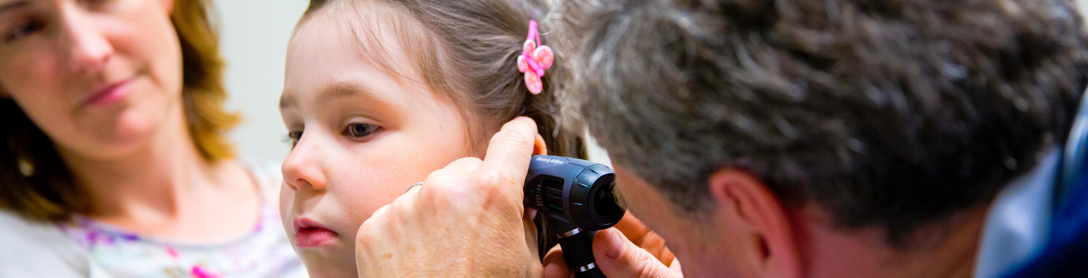 Doctor does an ear test on a young patient